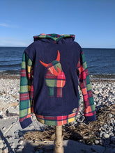 Load image into Gallery viewer, Navy blue hoody with a cute highland cow in Buchanan tartan. 
