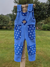 Load image into Gallery viewer, Kid&#39;s fleece dungarees in sky blue with blue stars.
